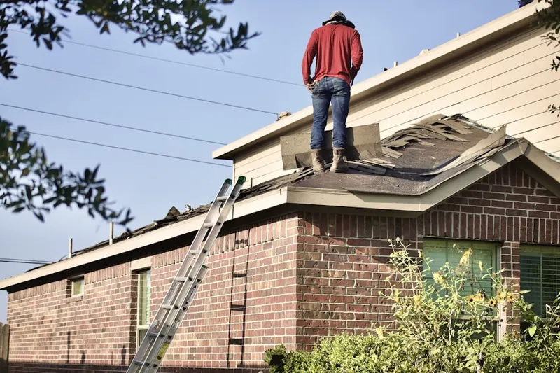 Professional roofer working on a residential roof in Burgundy Village